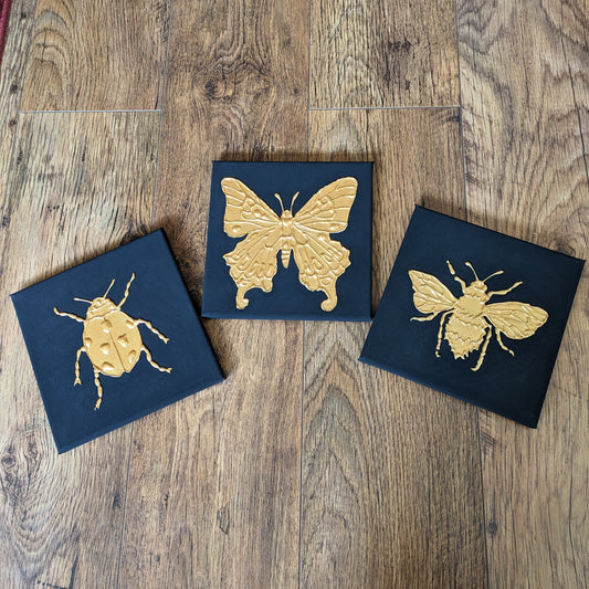 Set of three golden bug canvases