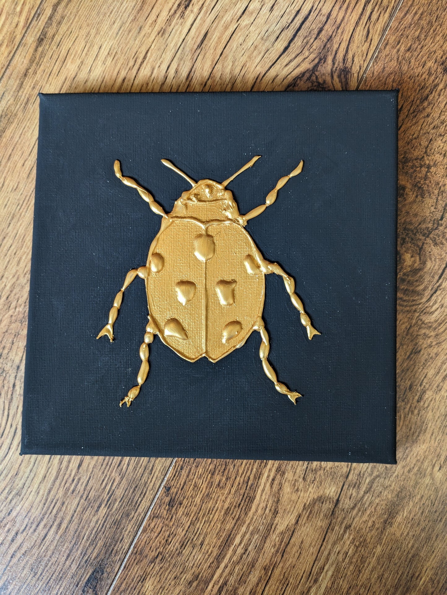 Set of three golden bug canvases